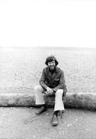 My hippie hubbie! Ritchie sitting on a log at Gold Beach, OR (1978)